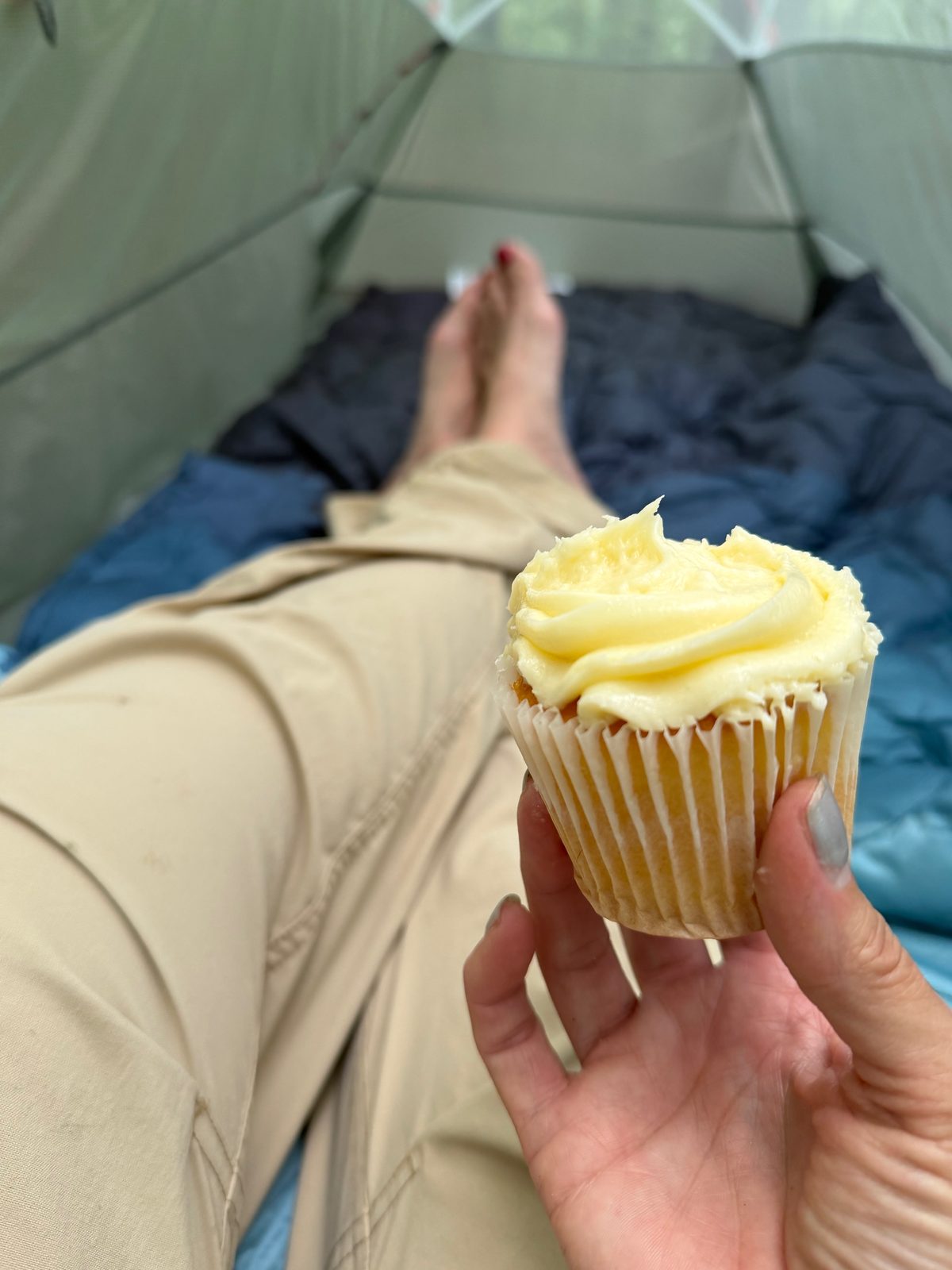 Holding a frosted birthday cupcake inside my tent