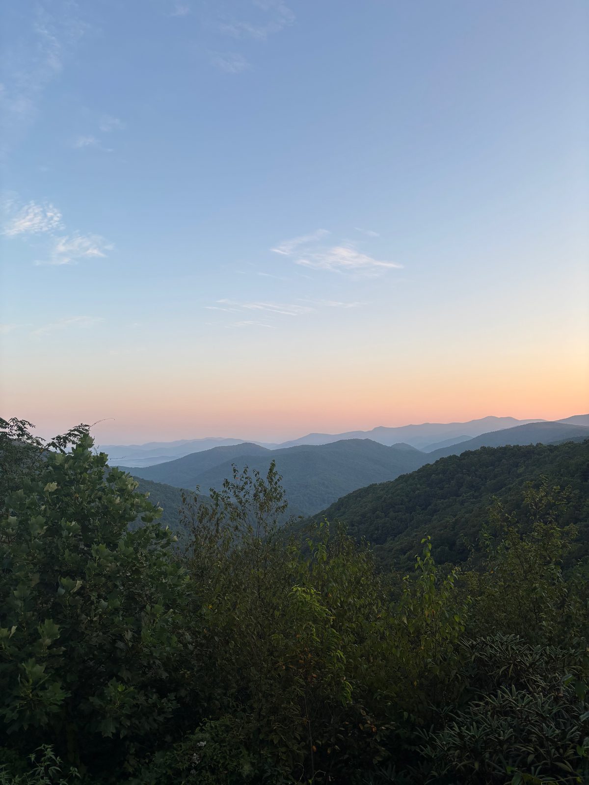 Sunset over layered mountain ridges