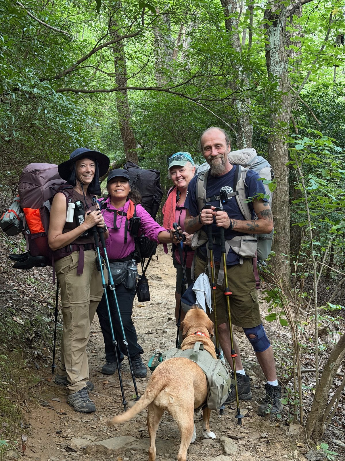 The full group on the trail with Sunshine the dog