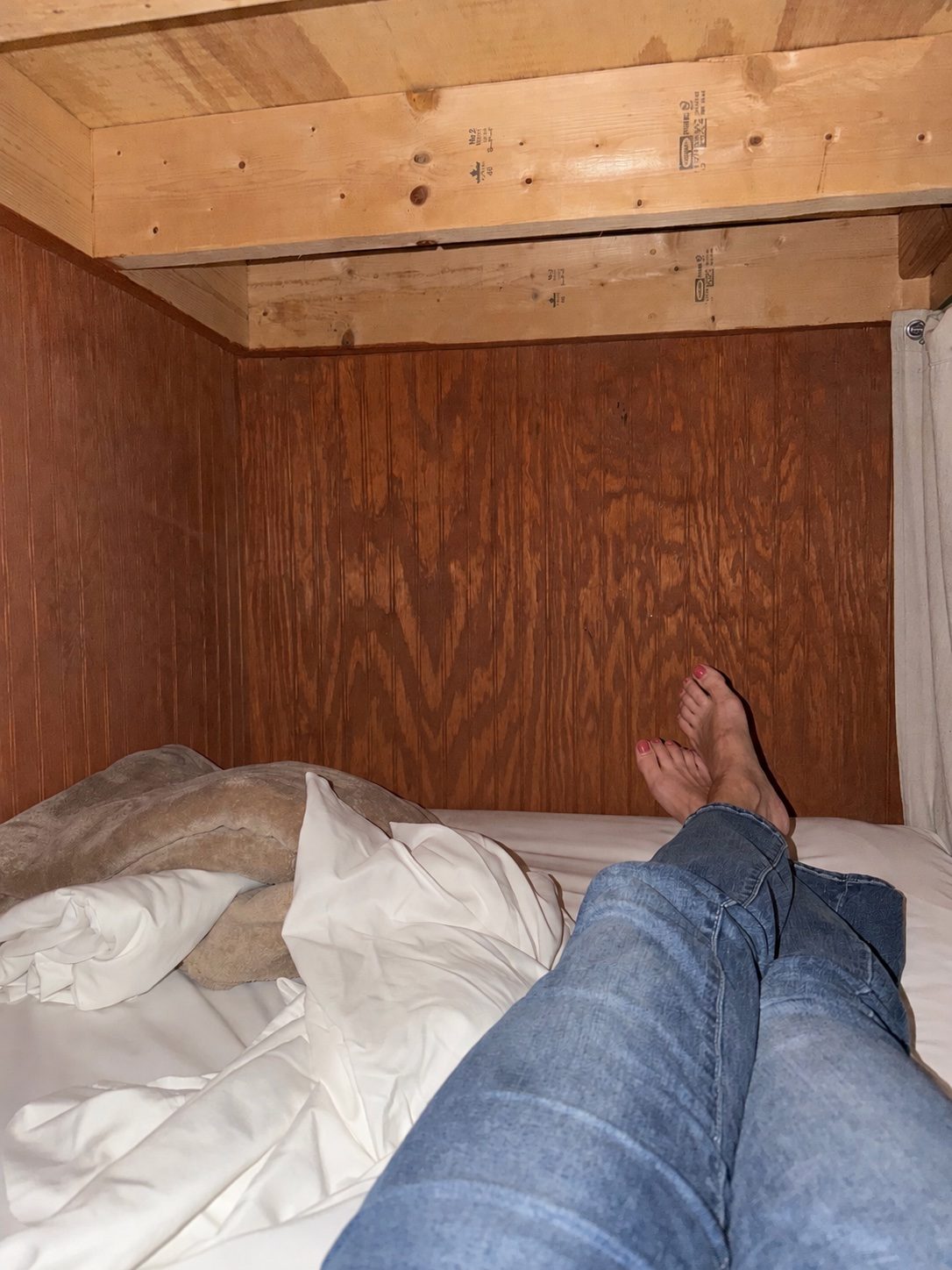 Feet up on a bunk bed at the hostel, arriving late at night